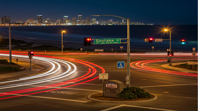 Phoenix skyline at night with red light trails from traffic