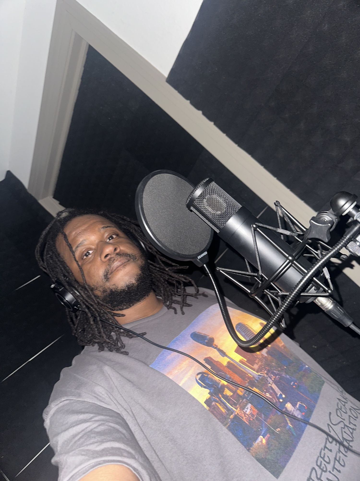 MT The Great at the microphone in the studio wearing a Streets 2 Speakers International shirt